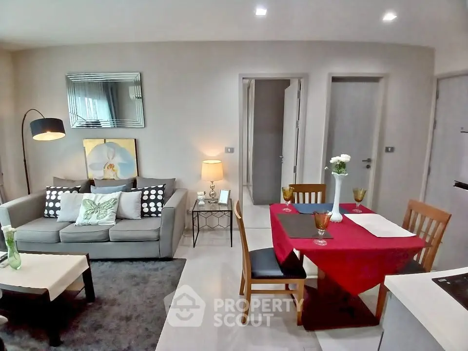 Chic modern living room with dining area, stylish decor, and cozy ambiance in a contemporary apartment.