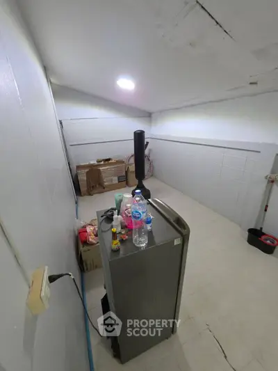 Spacious storage room with ample lighting and organized shelving potential.