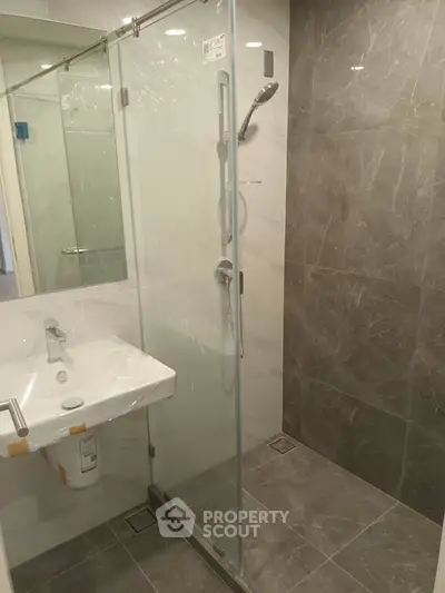 Modern bathroom with sleek glass shower and elegant tile design