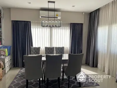 Elegant dining room with modern chandelier and stylish gray chairs