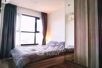 Modern bedroom with large window and stylish wooden wardrobe