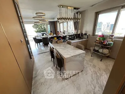 Luxurious open-layout kitchen with marble dining table and city view, perfect for modern living.