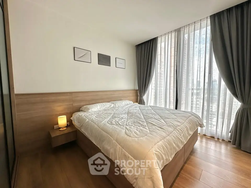 Modern bedroom with large window and stylish decor