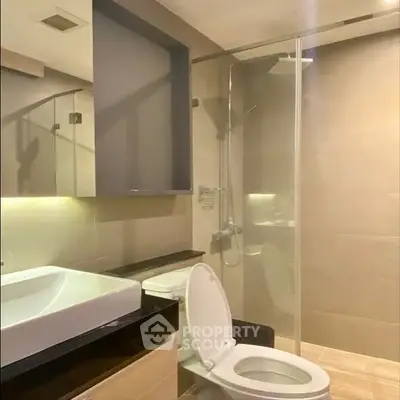 Modern bathroom with glass shower and sleek fixtures