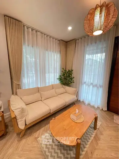 Cozy living room with elegant sofa, wooden coffee table, and stylish lighting.