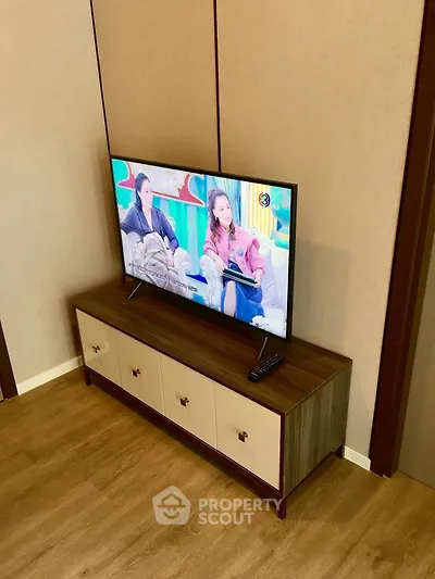 Modern living room with stylish TV stand and flat-screen television