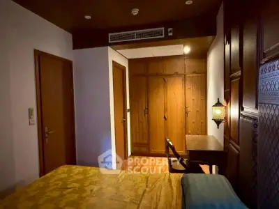 Cozy bedroom with wooden furniture and warm lighting, perfect for relaxation.