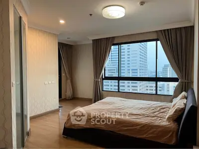 Spacious bedroom with city view in modern high-rise apartment
