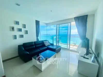 Stunning living room with panoramic ocean view and modern furnishings.