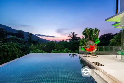 Luxurious infinity pool with stunning sunset view and modern outdoor seating