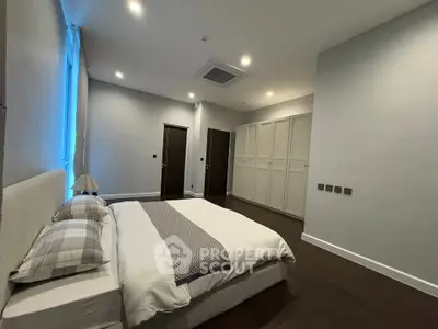 Spacious modern bedroom with elegant design and ample storage space
