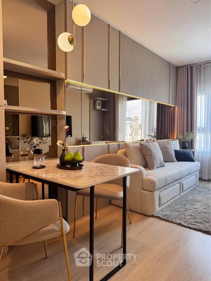 Stylish modern living room with elegant decor and large mirror enhancing space.