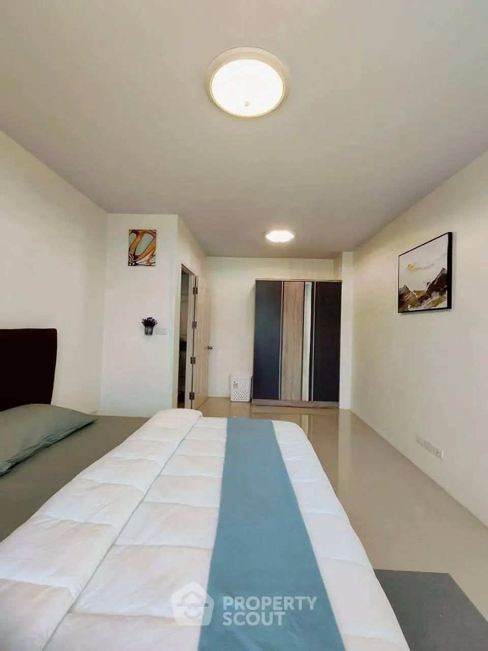 Spacious bedroom with modern decor and ample natural light
