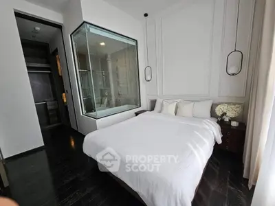 Luxurious bedroom with modern glass-enclosed shower and elegant decor