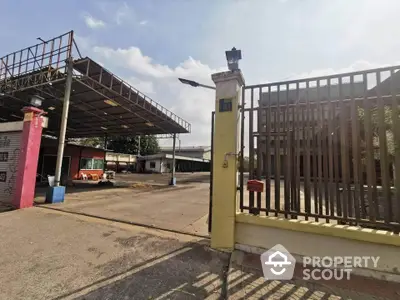 Spacious industrial property with large open area and secure gated entrance.