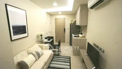 Modern compact living room with open kitchen in stylish apartment