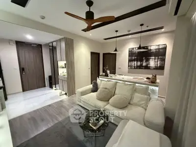Modern living room with stylish decor and open layout, featuring cozy seating and elegant lighting.