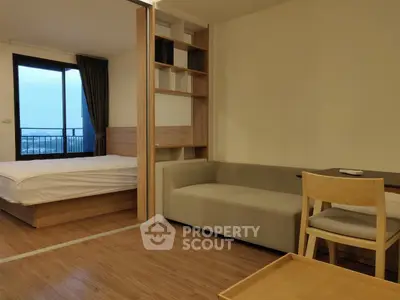 Modern studio apartment with wooden flooring and cozy furniture