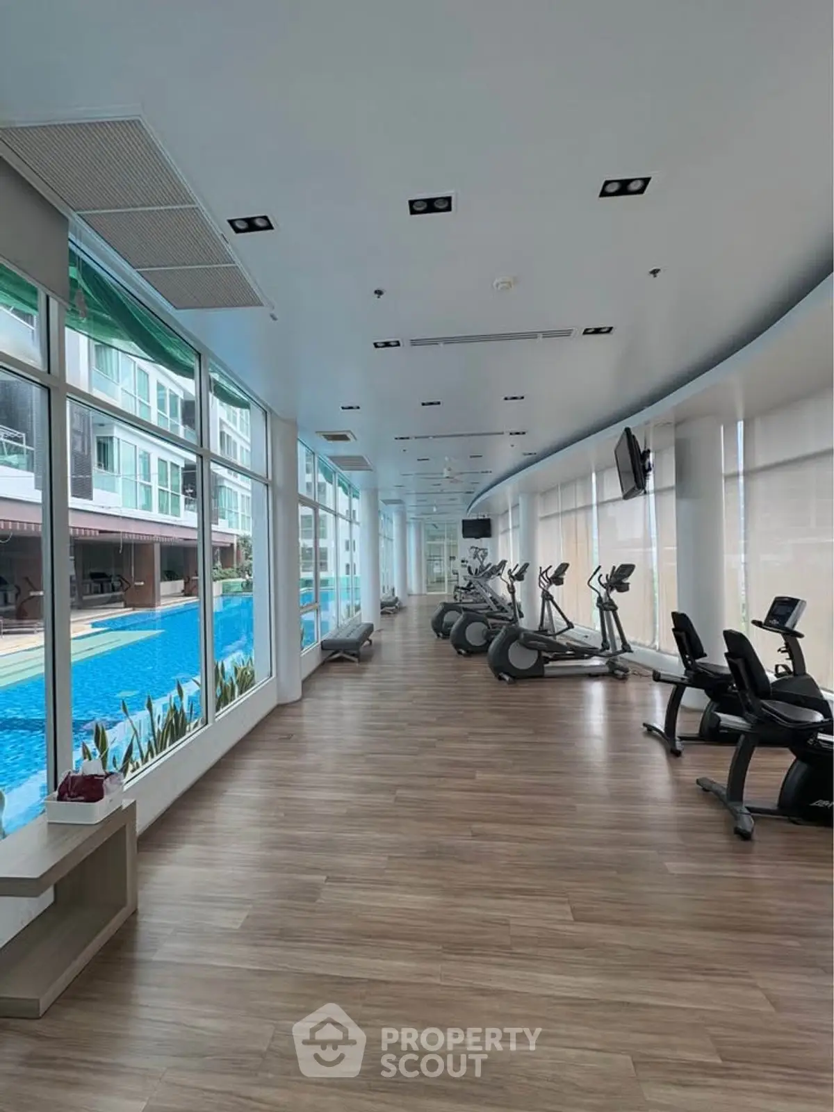 Modern gym with pool view and state-of-the-art equipment