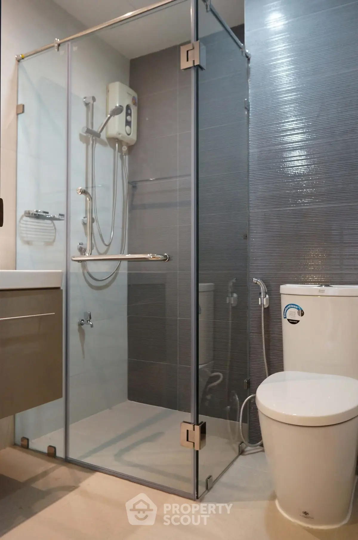 Modern bathroom with glass shower enclosure and sleek fixtures