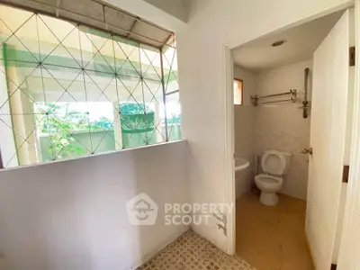 Spacious bathroom with natural light and outdoor view