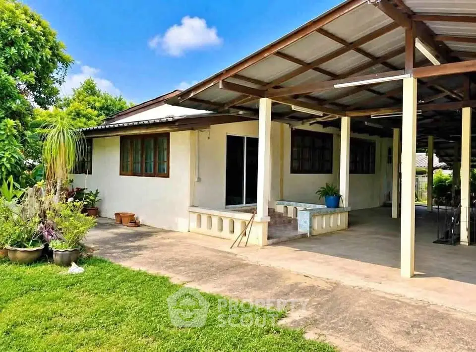 Charming single-story home with spacious outdoor area and lush greenery, perfect for family living.