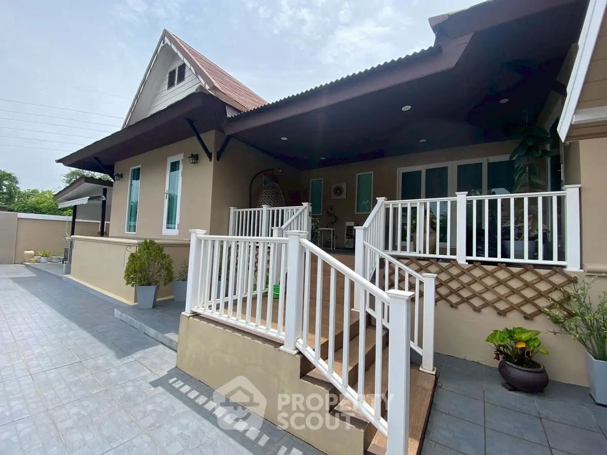 Charming single-story home with inviting front porch and modern railing