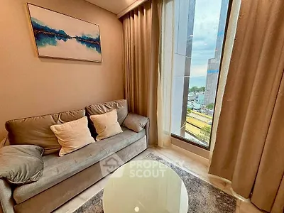 Cozy living room with modern decor and large window offering city view.