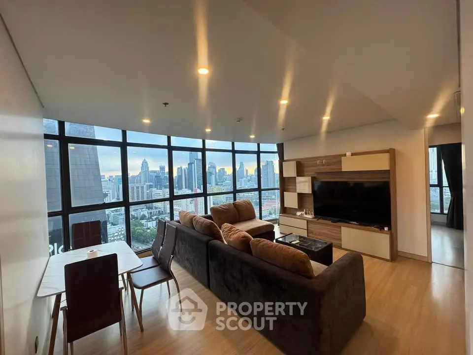 Luxurious living room with stunning city skyline view, modern furniture, and floor-to-ceiling windows.