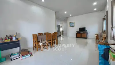 Spacious living room with dining area and modern decor, perfect for family gatherings.