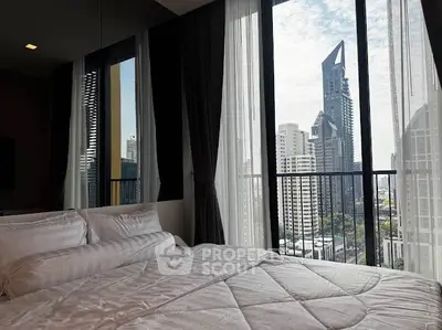 Luxurious bedroom with stunning city view and floor-to-ceiling windows.