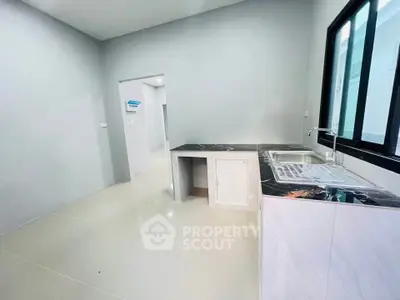 Modern kitchen with sleek countertops and ample natural light.