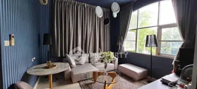 Stylish living room with modern decor and large windows for natural light