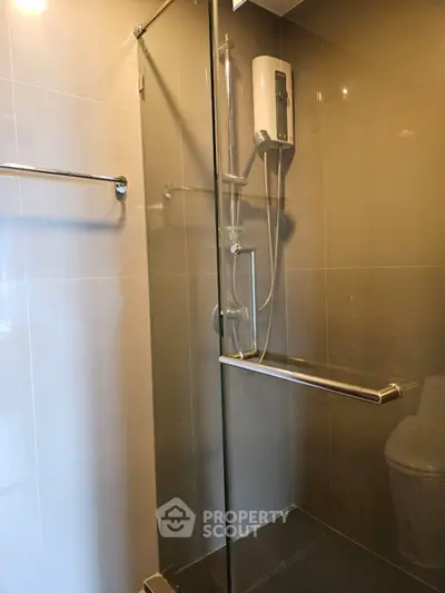 Modern bathroom with glass shower enclosure and sleek fixtures