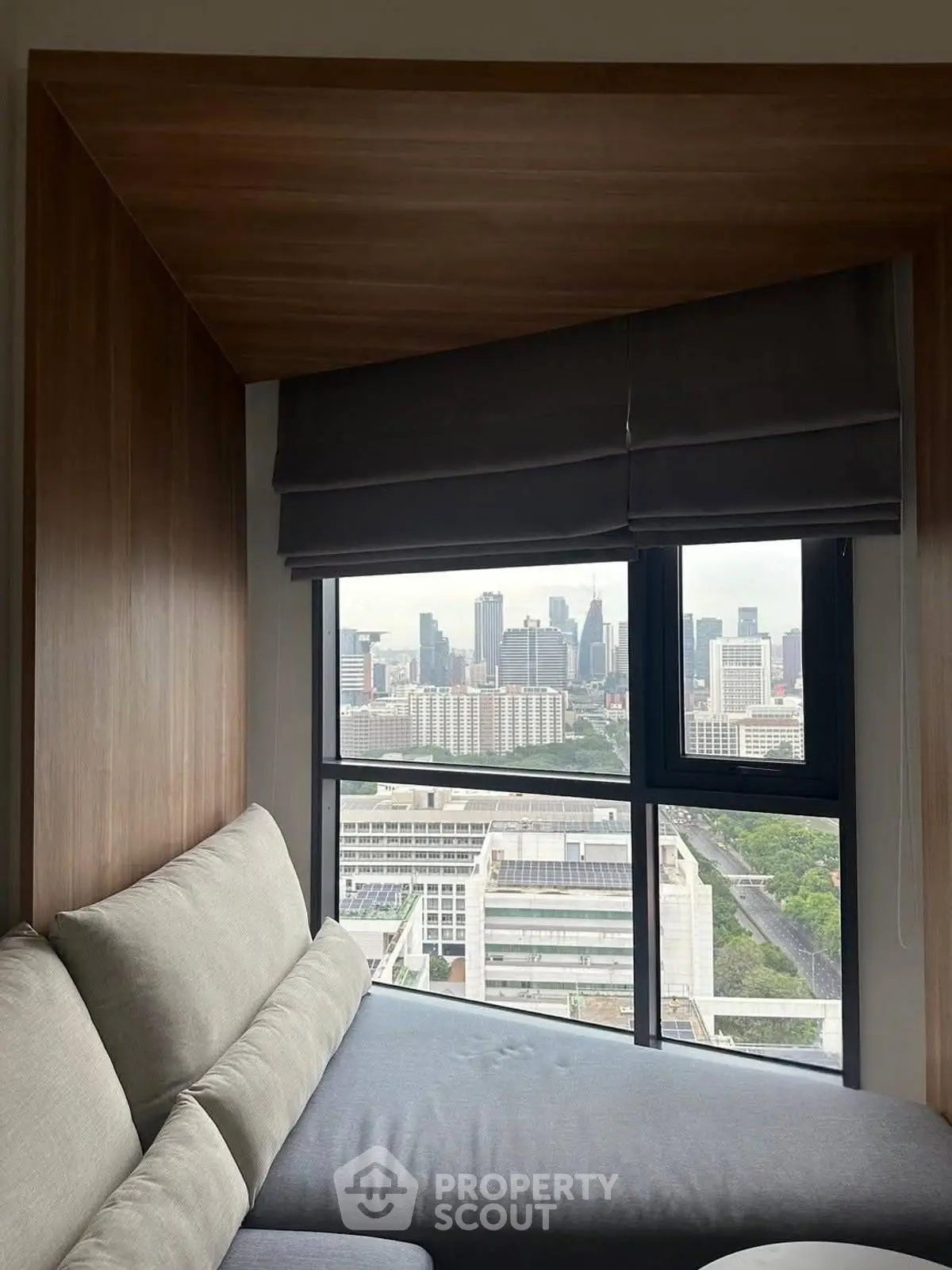 Cozy corner unit with stunning city view from a modern apartment window.