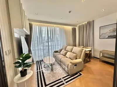 Modern living room with stylish decor and large windows in a luxury apartment.