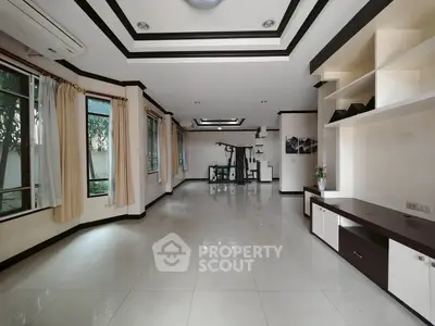 Spacious living room with large windows and modern decor