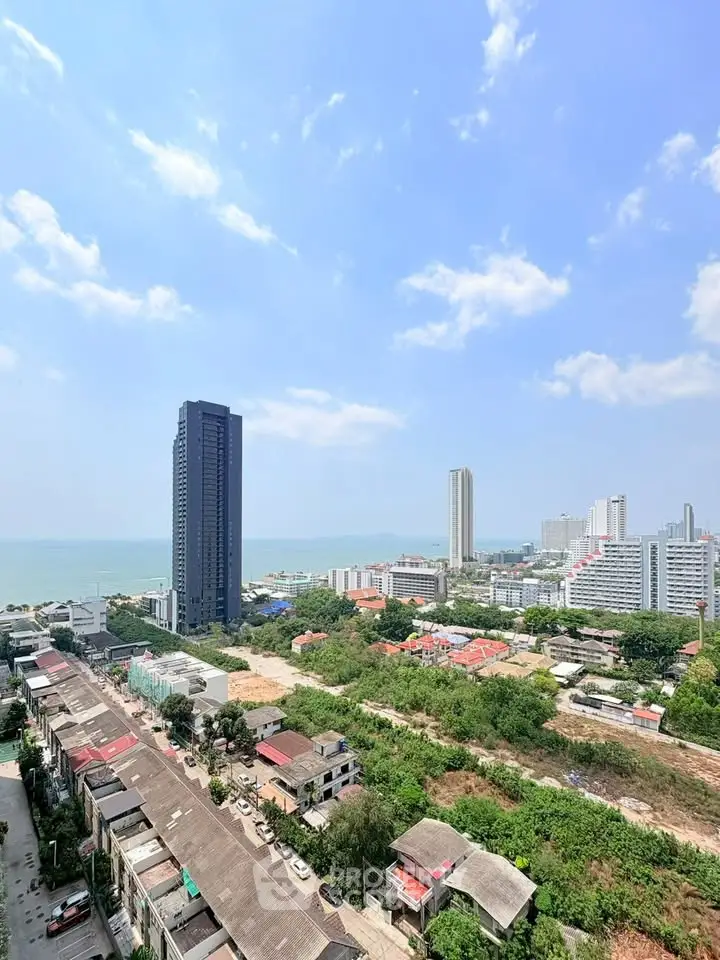 Stunning coastal cityscape view with modern high-rise buildings and ocean backdrop.