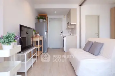 Modern living room with sleek furniture and open kitchen layout