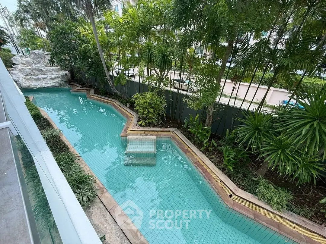 Stunning pool surrounded by lush greenery in a serene residential setting.