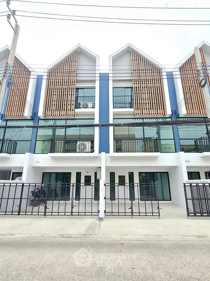 Modern townhouse exterior with unique architectural design and large windows, perfect for urban living.