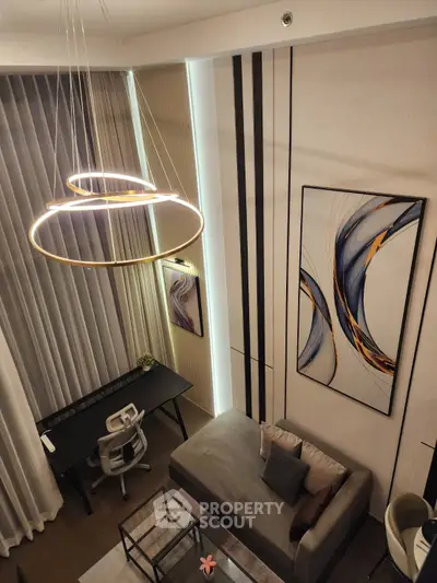 Modern living room with high ceiling, stylish chandelier, and contemporary decor in a luxurious apartment.