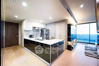 Modern open-layout kitchen with sleek design and spacious living area