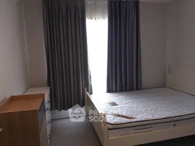 Cozy bedroom with elegant curtains and stylish furniture, perfect for relaxation.