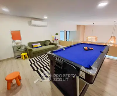 Stylish recreation room with pool table and modern decor in a contemporary home.