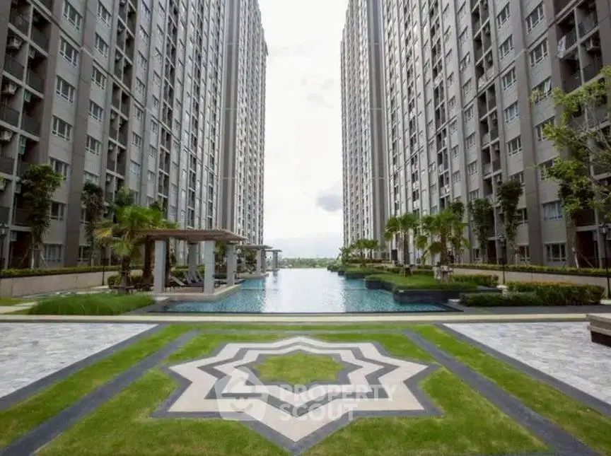 Luxurious high-rise apartment complex with stunning pool and landscaped garden.