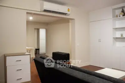 Modern living room with sleek furniture and built-in storage