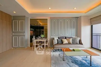 Elegant living room with modern decor and dining area, featuring stylish lighting and large windows.