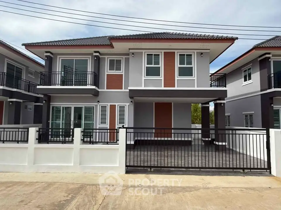 Modern two-story house with sleek design and spacious driveway in a suburban neighborhood.