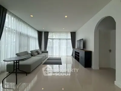 Spacious modern living room with large windows and sleek furniture